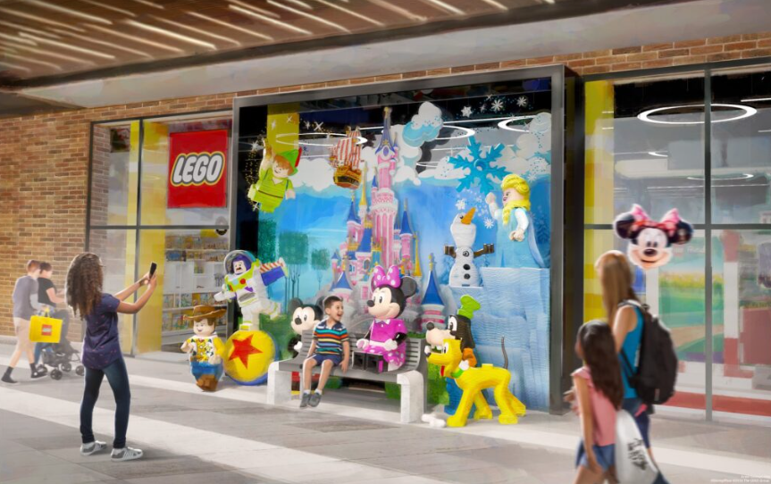 An image showing a boy sat next to Minnie Mouse made of lego.